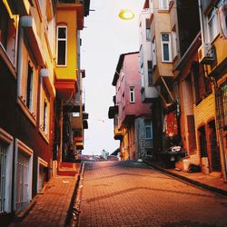 Empty street amidst buildings in city