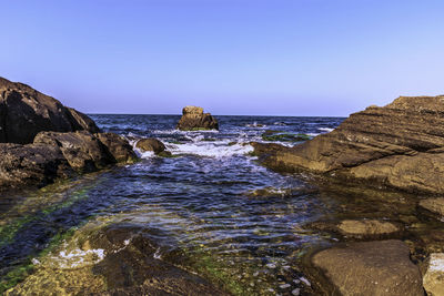 Scenic view of sea against clear blue sky