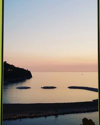Scenic view of sea against clear sky during sunset