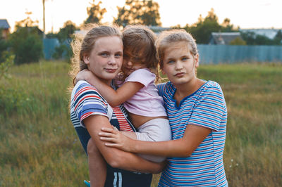 Portrait of siblings on field