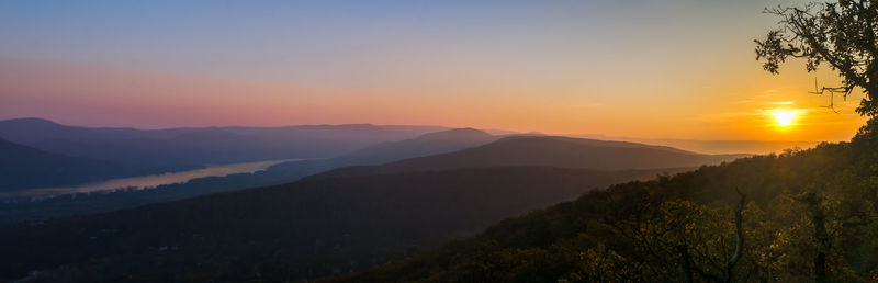 Scenic view of silhouette mountains against sky during sunset