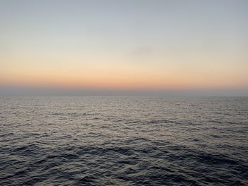 Scenic view of sea against clear sky during sunset