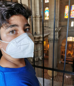 View of young boy with mask in a rooftop tour in malaga's cathedral during the pandemic.