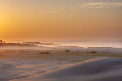 Scenic view of landscape against sky during sunset