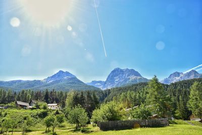 Scenic view of mountains against blue sky