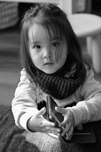 Portrait of cute girl sitting outdoors