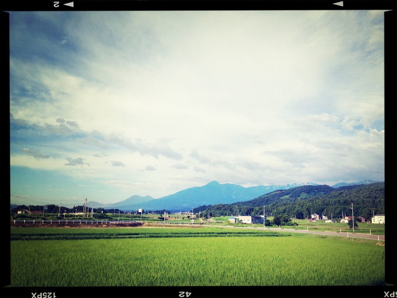 transfer print, sky, grass, mountain, landscape, cloud - sky, auto post production filter, field, cloud, mountain range, scenics, tranquil scene, beauty in nature, green color, cloudy, nature, building exterior, tranquility, day, built structure