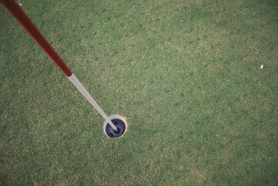 High angle view of golf flag in hole