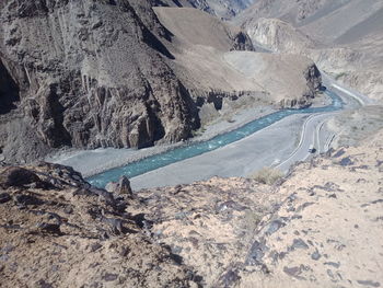 High angle view of rocks on road by mountain