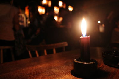 Close-up of illuminated candles on table