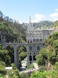 View of arch bridge and building against sky