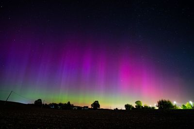Scenic view of landscape against sky at night