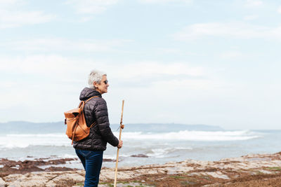 Full length of man on beach against sky