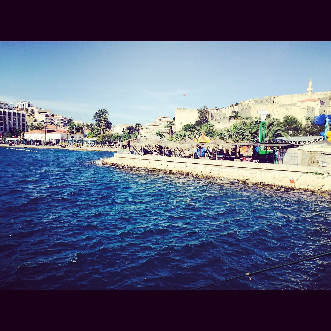 water, transfer print, clear sky, building exterior, sea, built structure, architecture, blue, waterfront, auto post production filter, copy space, city, rippled, swimming pool, incidental people, river, day, outdoors, nature, travel destinations