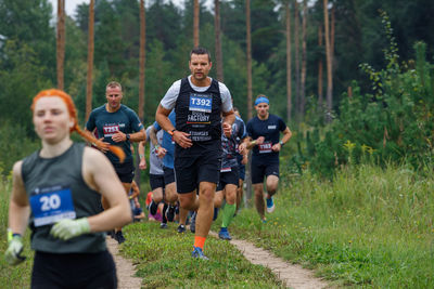 Group of people running on grassland