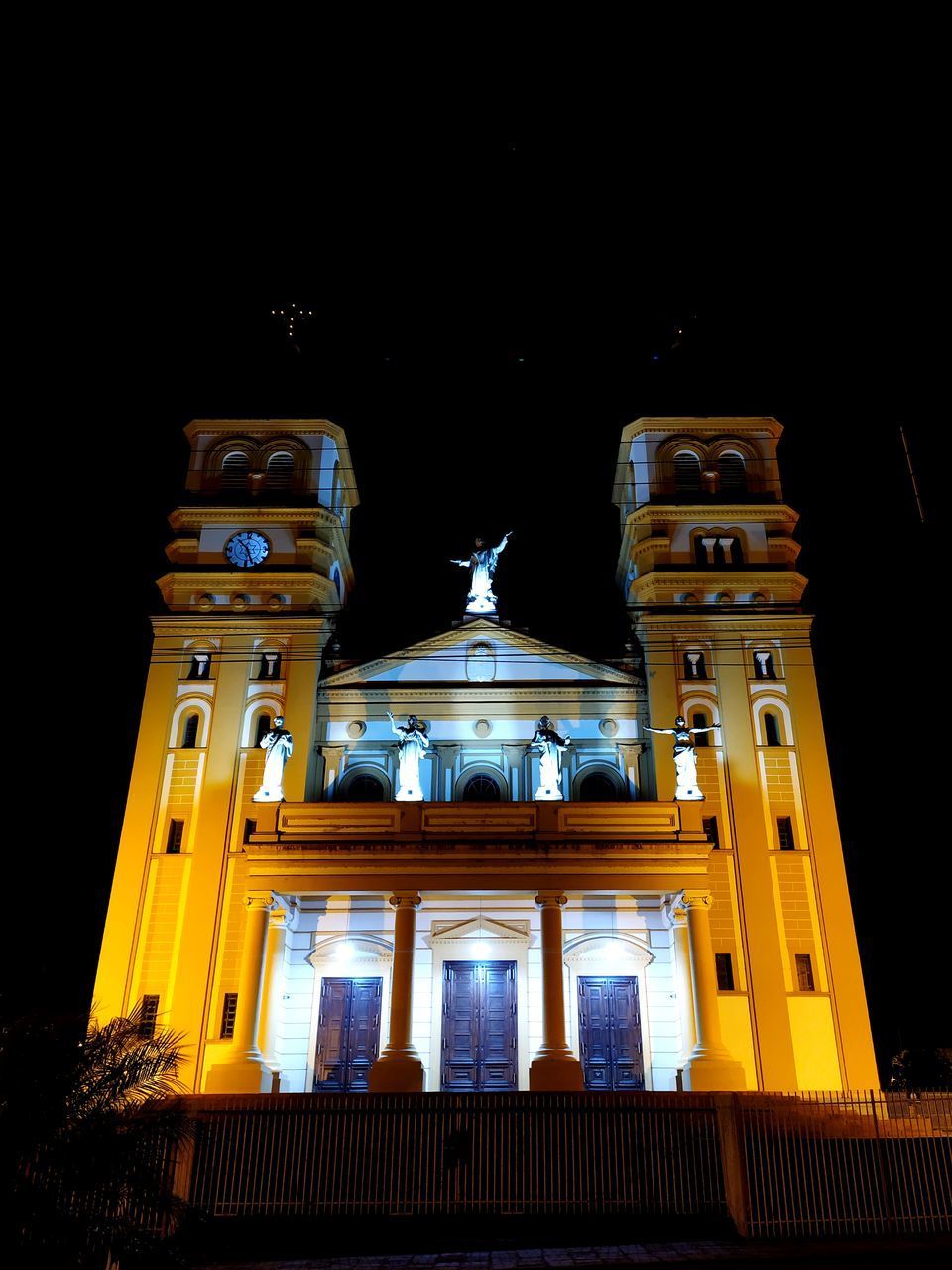 LOW ANGLE VIEW OF ILLUMINATED BUILDING AGAINST SKY