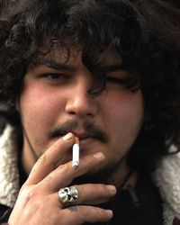 Close-up portrait of man smoking cigarette