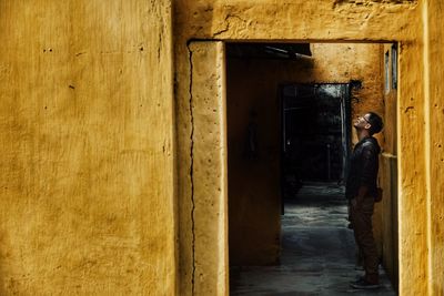 Man standing at entrance of building