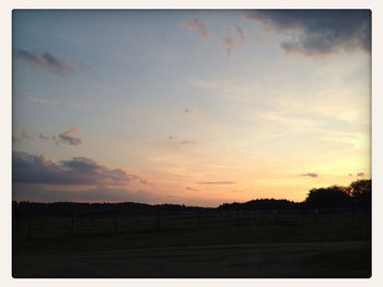 Scenic view of landscape against sky at sunset