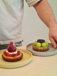 Midsection of man holding food on table