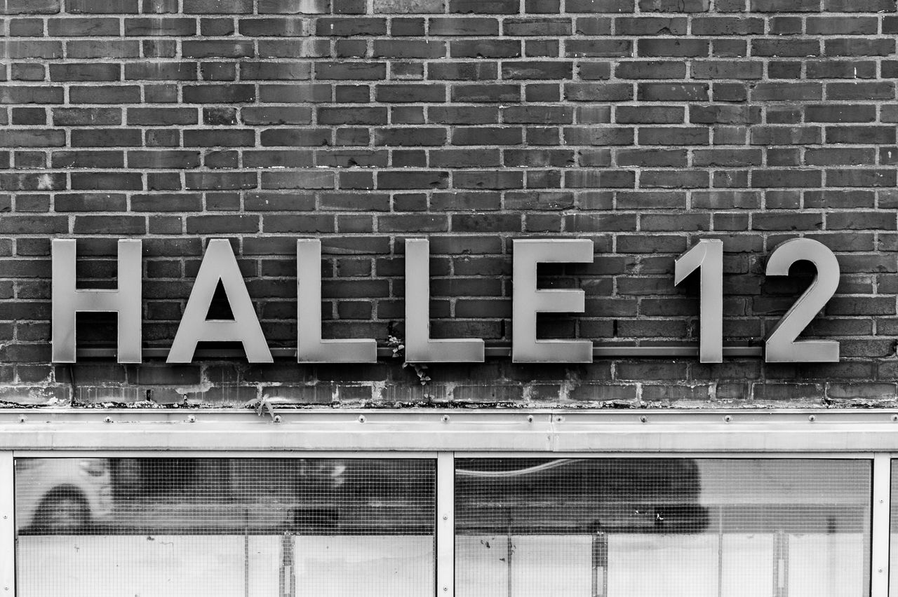 brick wall, communication, text, architecture, no people, built structure, exit sign, outdoors, day