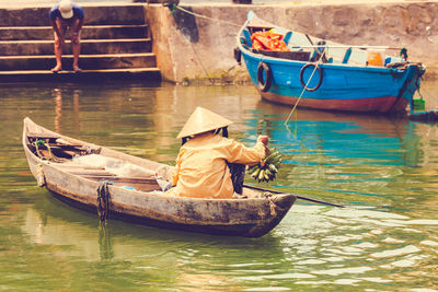 Person sailing boat on lake