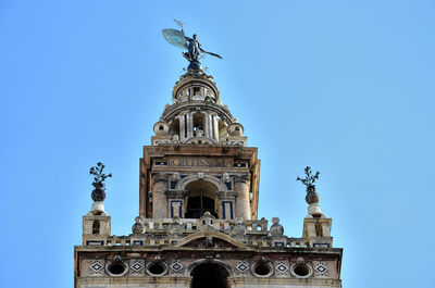 Low angle view of statue against blue sky