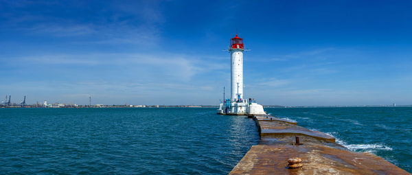 Lighthouse at the entrance to the harbor of odessa seaport, on a sunny summer day