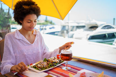 Portrait of young woman having food