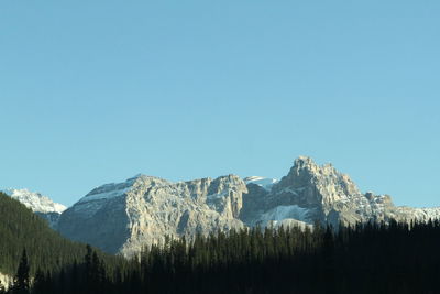 Scenic view of snowcapped mountains against clear blue sky