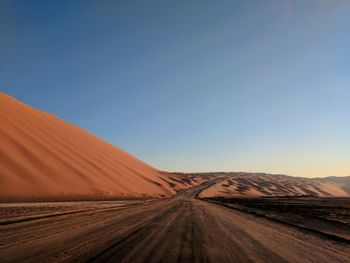 Panoramic view of desert against clear sky