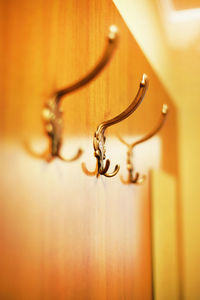 Low angle view of hooks on wooden door at home