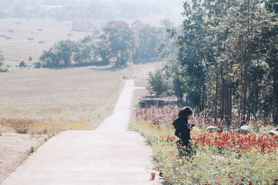 Full length of woman standing on roadside