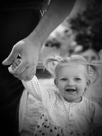 Little girl holding hands with daddy