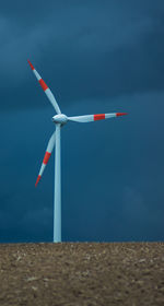 Windmill on field against sky