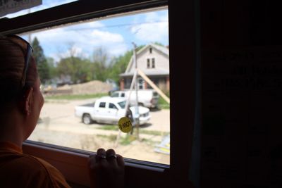 Cropped image of woman looking through window while traveling