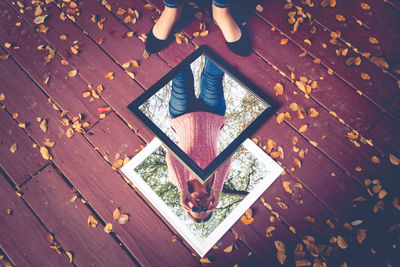 Low section of woman standing on wooden floor