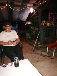 Portrait of man sitting on chair at table