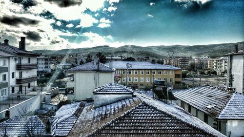 Residential buildings against cloudy sky