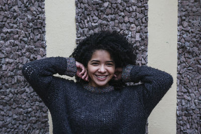Portrait of a smiling young woman standing outdoors