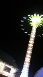 Low angle view of illuminated ferris wheel