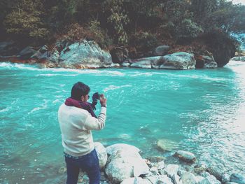 Man photographing sea