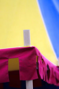 Low angle view of clothes drying against blue wall