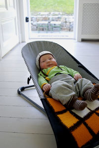 High angle view of baby lying on hammock at home