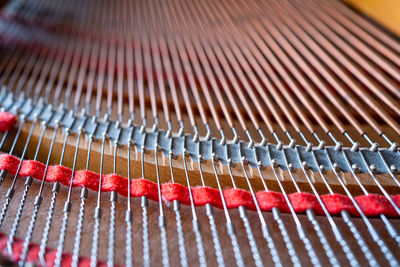 Close up image of interior of grand piano showing strings and structure