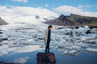 Woman standing on snow covered mountain