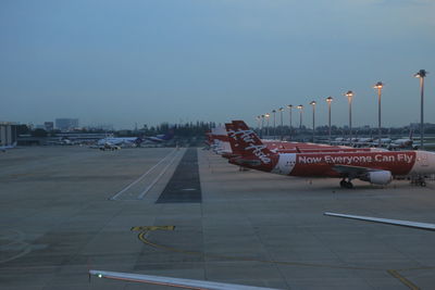 View of airplane on airport runway against sky