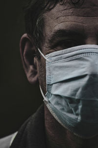 Close-up portrait of man covering face