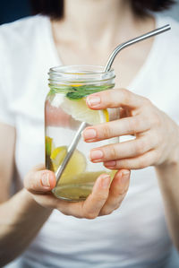 Cropped image of woman holding drink