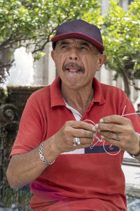 Portrait of young man holding paper currency